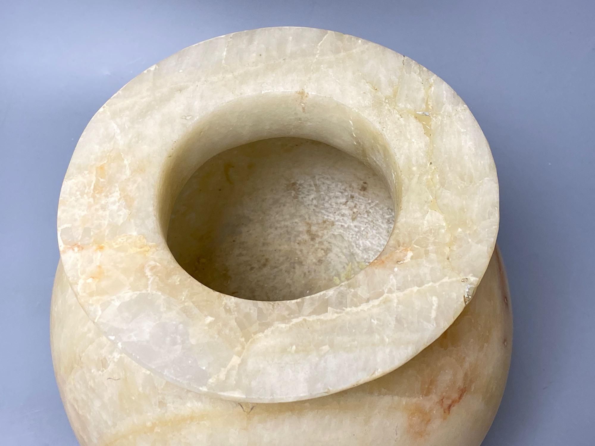 An alabaster bowl with everted rim, height 27cm